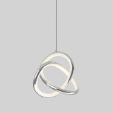 A modern pendant light featuring two interlocking rings, one emitting a soft white glow and the other metallic, suspended from a single cord against a plain grey background.
