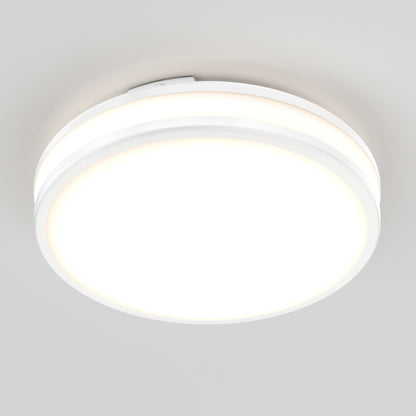 The Artika Hemisphere 15 in. LED flush mount light (5 CCT), a round and modern white fixture, is mounted on a plain white ceiling and brightly illuminated.