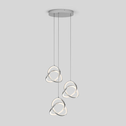 The Artika Zephyr 3-light LED pendant features three intertwined, glowing ring-shaped lights suspended at varying lengths from a round ceiling mount, creating a modern look against a plain background.