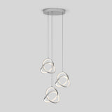A modern ceiling light fixture with three hanging LED pendants, each shaped like an abstract metallic loop with glowing edges, suspended from a round base against a plain light gray background.