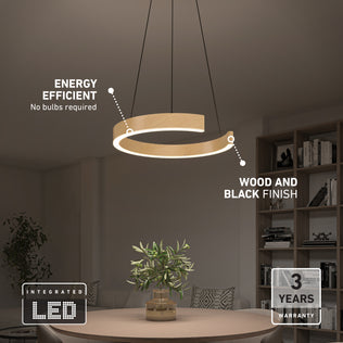 Modern dining room with the Artika Vance modern LED pendant light 3 CCT, featuring a circular wood and black finish, integrated LED for energy efficiency, and a 3-year warranty, hanging above a table with a plant.