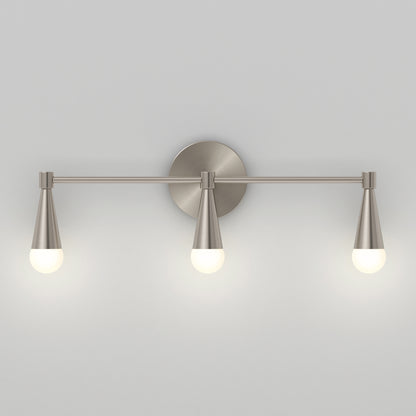 The Artika Wayden LED mid-century bathroom vanity light 3 CCT features a brushed nickel finish with three conical shades and round white bulbs, mounted on a circular wall plate, shown against a plain light gray background.