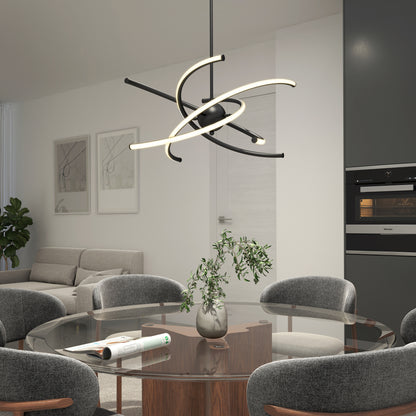 A modern dining room with a round glass table, four gray upholstered chairs, a decorative plant centerpiece, and the Artika Silvio LED pendant light 3 CCT hanging above. A gray sofa and wall art appear in the background.