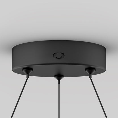 Close-up of the Artika Bjorn modern LED pendant light 5 CCTs round matte black ceiling mount with three black cords, shown against a plain light gray background.