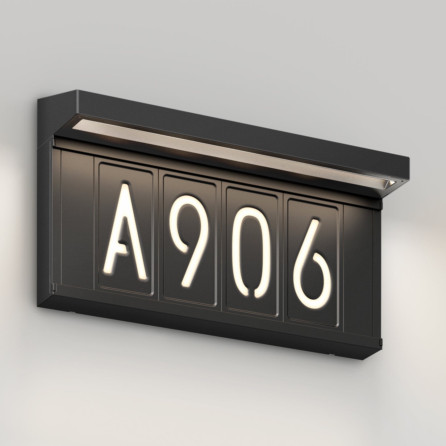 The Artika Bowen solar LED outdoor address wall light 5 CCT is a black, rectangular, wall-mounted sign with illuminated white numbers beneath a small ledge—ideal for maintenance-free, elegant address display on light gray walls.