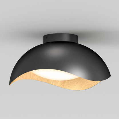 The Artika Adara 15 in. LED flush mount light features a matte black dome-shaped shade with a curved wooden accent, offering soft white illumination in 5 CCT options, perfect for modern interiors.