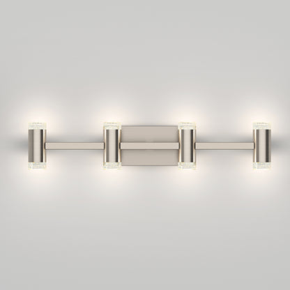 The Artika Mist modern LED bathroom vanity light 5 CCT features a sleek brushed metal finish with four evenly spaced cylindrical lights, casting a soft white glow against a plain light gray wall.