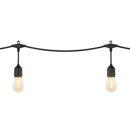 Two Blaze 20 LED Outdoor Solar String Lights by Artika hang from a black wire against a white background, their exposed vintage-style bulbs glowing warmly.