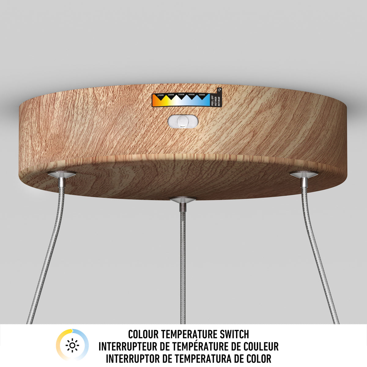 A wooden ceiling fixture with hanging cables features a color temperature switch and a multicolored temperature indicator above a white button. Text below reads, Colour temperature switch in English, French, and Spanish.