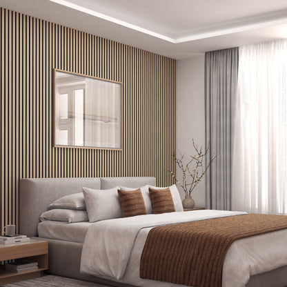 A modern bedroom featuring Artikas Sonolok sound-absorbing wall panel kit, a light gray bed with brown accent pillows and blanket, large window with sheer curtains, nightstand, and a minimalist vase with branches.