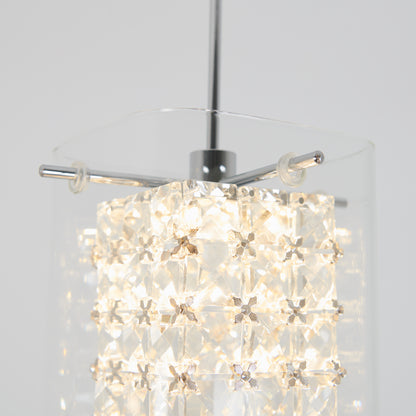 Close-up of the Artika Crystal Cube 1-light LED pendant, featuring a metal rod, clear glass outer shade, and an illuminated inner section adorned with star-shaped crystal accents.