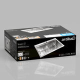 A rectangular box with artika branding displays a Newport 33-inch stainless steel kitchen sink. The box shows the sinks image, features, and installation instructions on a reflective gray surface.