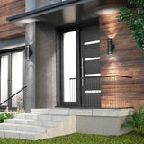 A modern front entrance with concrete steps, a black metal railing, a sleek black door with horizontal glass panels, wall-mounted lights, and contemporary wood and gray exterior walls.