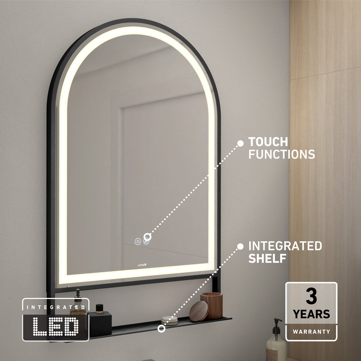 A modern arched mirror with an integrated LED light, touch functions, and a small black shelf. The mirror is mounted on a gray wall above a bathroom counter. A “3 years warranty” label is in the lower right corner.