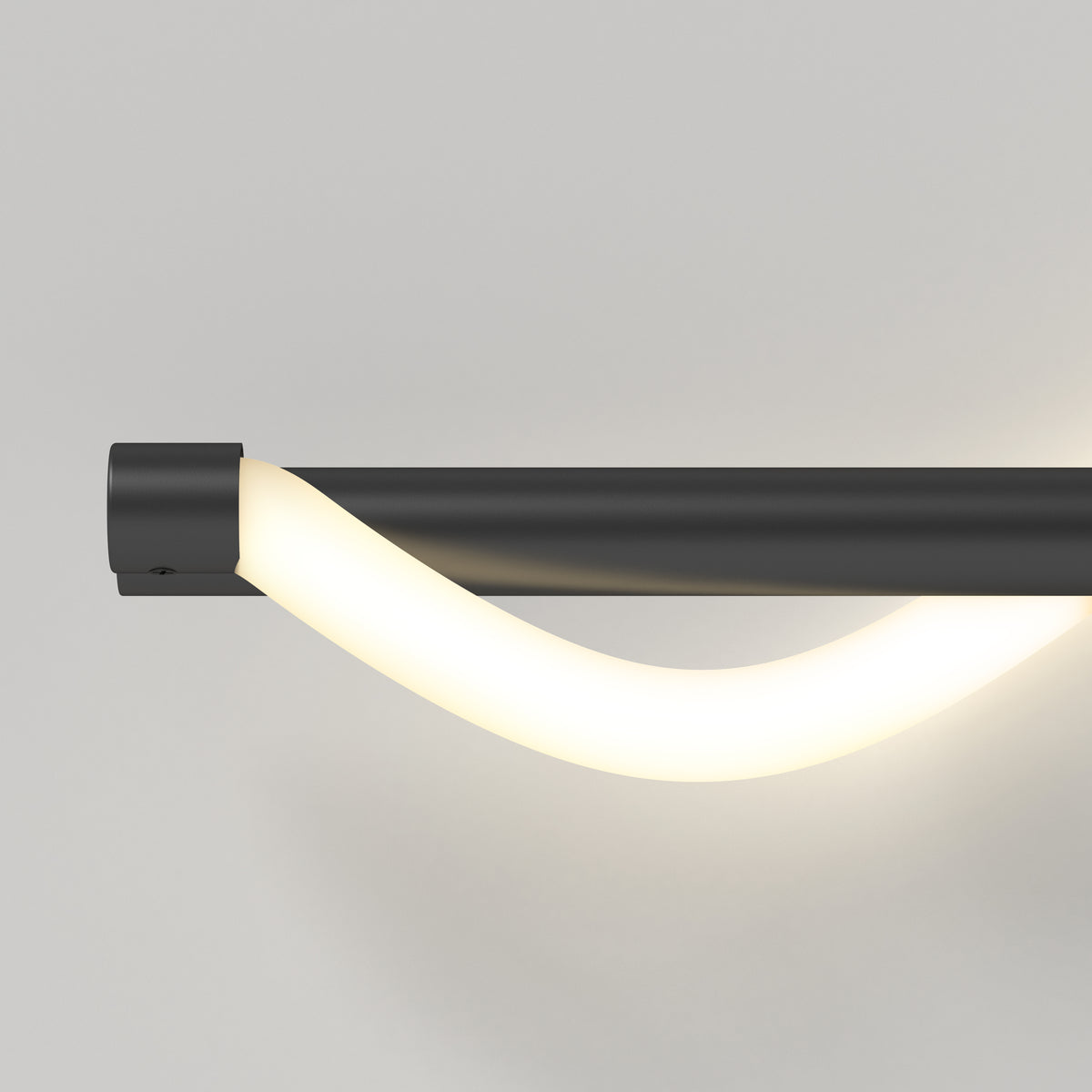 A modern wall-mounted light fixture with a sleek black base and a curved, glowing white LED tube, set against a plain light gray background.