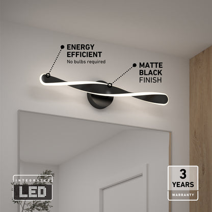 The Artika Finley LED modern bathroom vanity light, in matte black, is mounted above a mirror. Its energy efficient, needs no bulbs, and comes with a 3-year warranty—ideal for clean, minimal spaces.