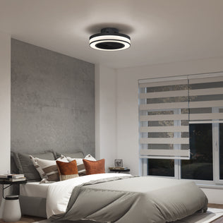 A modern bedroom with a neatly made bed, accent pillows, side tables, and the Artika Elton 19.4 in. LED modern ceiling fan with 3 speeds and remote. The space also features layered blinds on a large window and neutral minimalist decor.