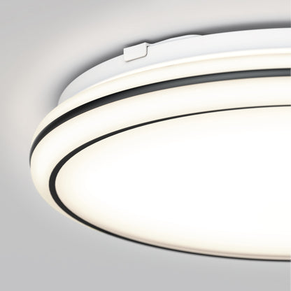 Close-up of the Artika Emina 13 in. LED flush mount light 3 CCT, featuring a modern white and black design and dimmable, even illumination against a light gray ceiling.