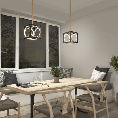 A modern dining area with a wooden table, four cushioned chairs, a potted plant, decorative pillows, and two Artika Astoria LED modern pendant lights overhead. A large window reveals an outdoor scene at dusk.