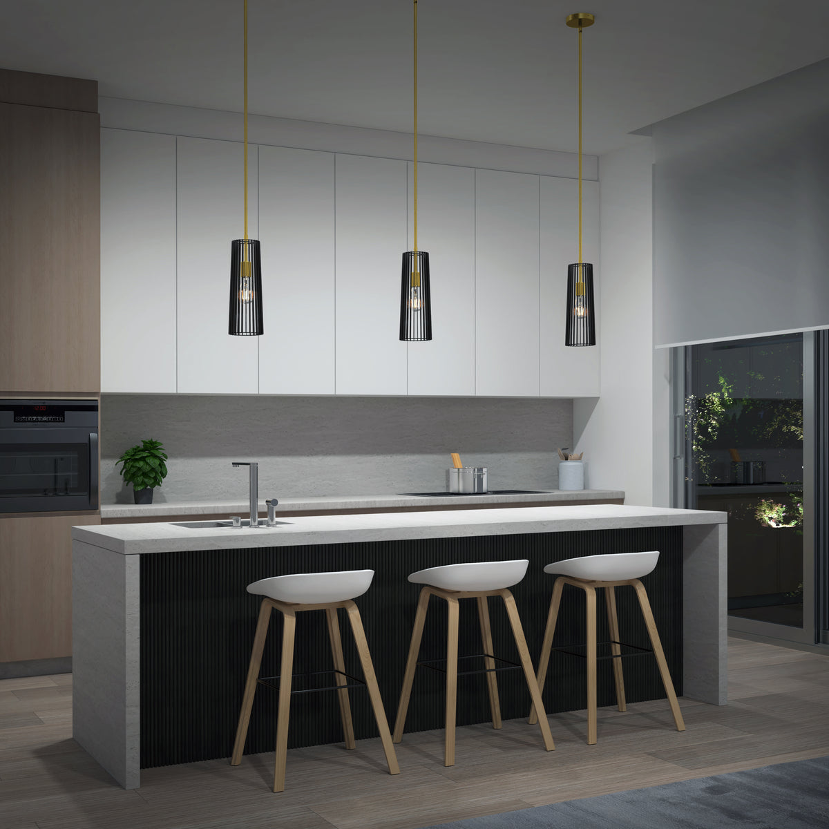Modern kitchen with a large island, three white bar stools, hanging pendant lights, sleek white cabinets, built-in oven, potted plant, and a window showing greenery outside at night.