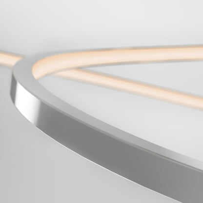 A close-up of the Salto LED pendant light by Artika, featuring a curved metallic design with a chrome finish and glowing LED strip. Its smooth, minimalist lines make it perfect for modern interior lighting against a white background.