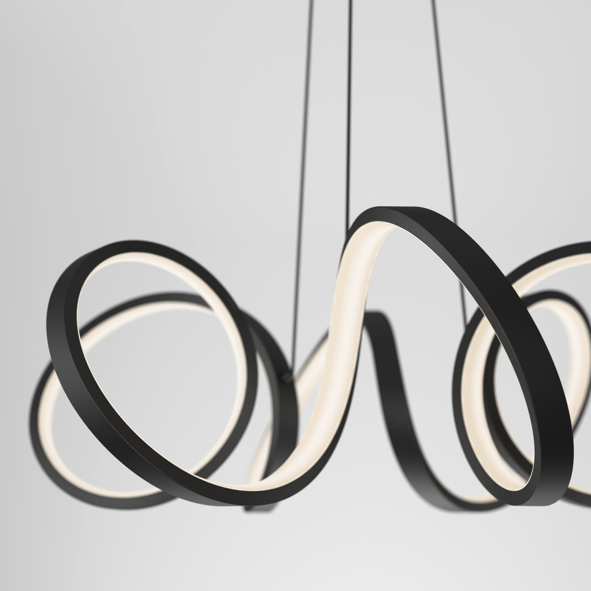 A modern black pendant light fixture with looping, curvy LED strips hanging from the ceiling against a plain white background.