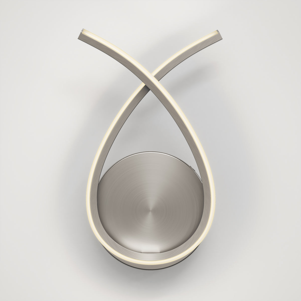 A modern wall-mounted light fixture with two curved metallic arms crossing at the top, forming a teardrop shape around a circular, brushed metal base. The fixture has LED strips on the inner edges of the arms.