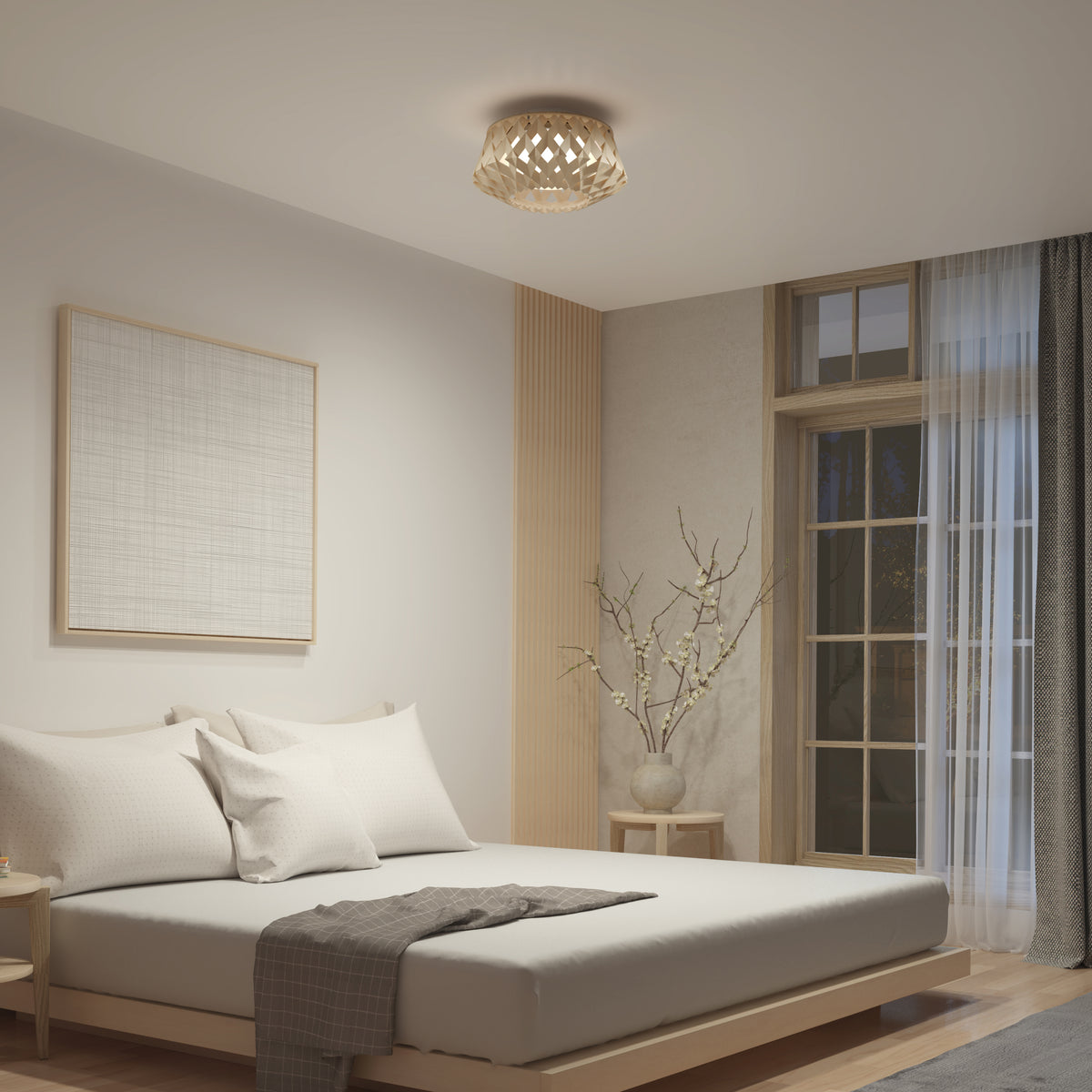 A modern, minimalist bedroom with a low wooden bed, white bedding, a gray throw, a simple nightstand, a large window with sheer curtains, a decorative branch in a vase, and a geometric ceiling light.