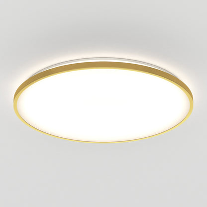 A modern, round ceiling light with a gold rim emits a bright, even glow against a white ceiling. The fixture has a sleek, minimalist design.