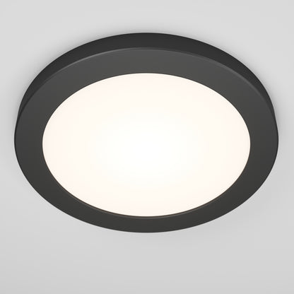 The Artika Europa Disk 7 in. LED modern flush mount light features a round design with a dark frame and bright white center, seamlessly mounted to a plain white ceiling. It offers 3 CCT options for versatile lighting.