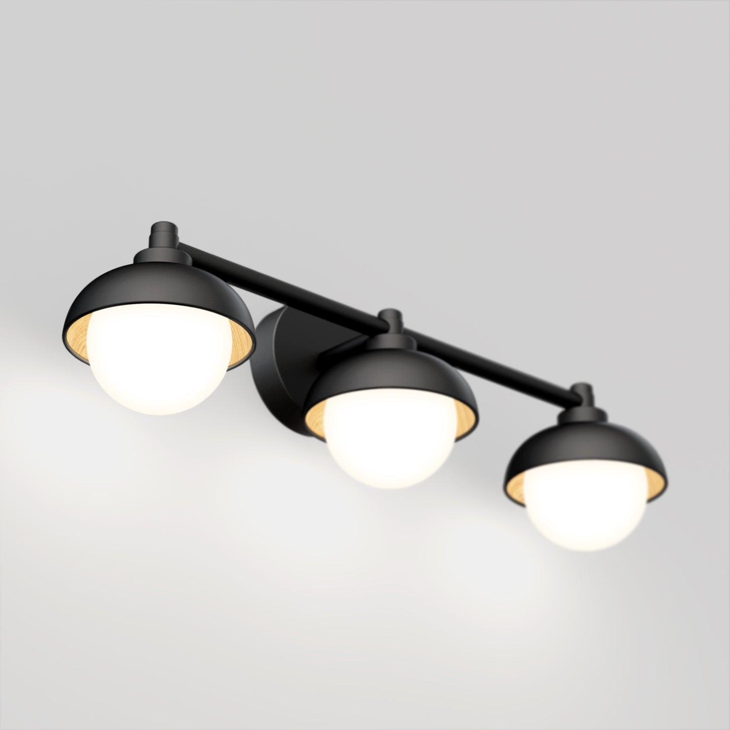 The Artika Boden LED mid-century bathroom vanity light features three round frosted glass shades on a modern black horizontal bar, each emitting soft white light.