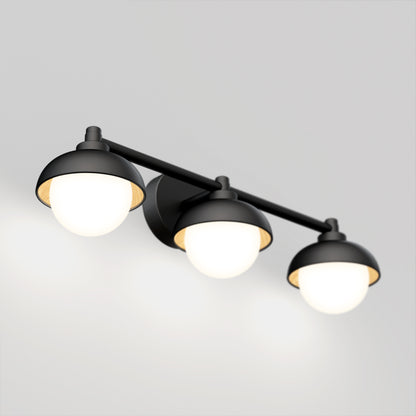 The Artika Boden LED mid-century bathroom vanity light features three round frosted glass shades on a modern black horizontal bar, each emitting soft white light.