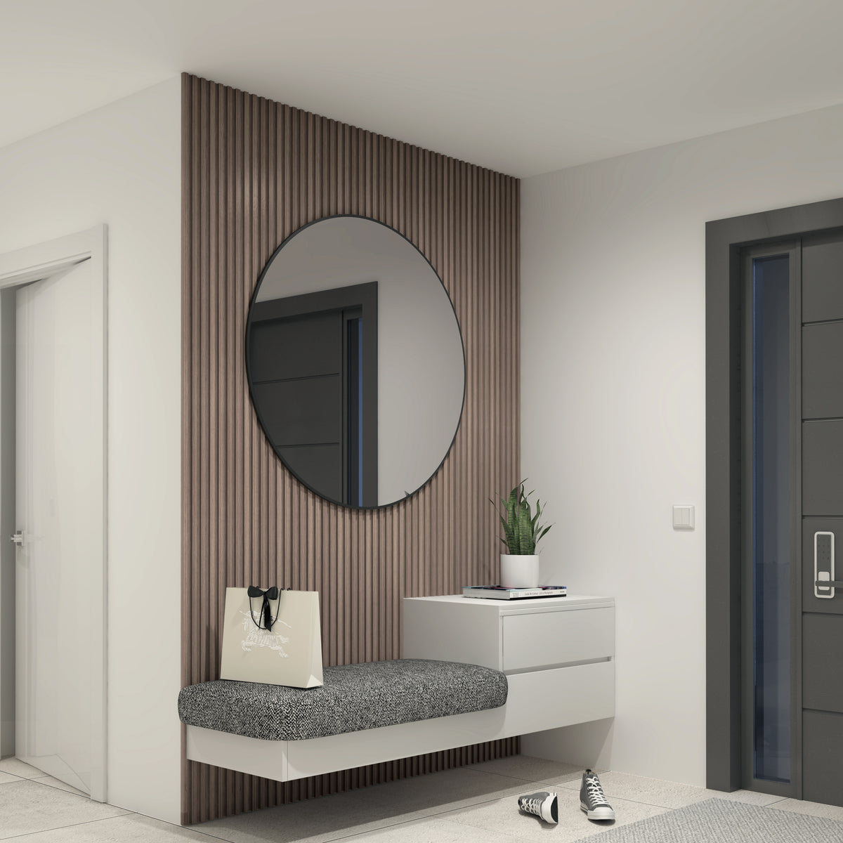 A modern entryway with a floating bench, a gray cushion, a white drawer, a potted plant, a shopping bag, sneakers on the floor, and a large round mirror above a wooden slat accent wall.