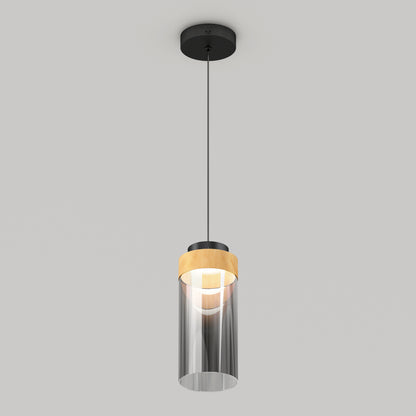 The Artika Hanson 1-light LED pendant 5 CCT features a black ceiling mount, black cord, and cylindrical glass shade with a wooden accent near the top, shown against a light gray background.