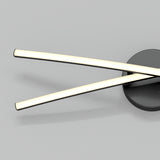 A modern wall light fixture with two slim, illuminated bars crossing each other, attached to a round, dark base on a light gray background.