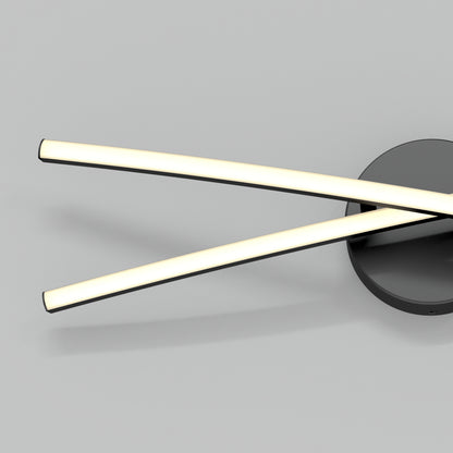 The Artika Orly modern LED bathroom vanity light 3 CCT features two curved LED bars crossing over each other, mounted on a round black base, and is shown against a plain light gray background.