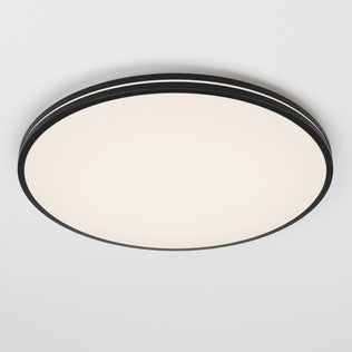 The Artika Athos 21 in. LED flush mount light features a modern round design with a black rim, smooth white illuminated surface, and comes with a remote for easy control, shown mounted on a plain white ceiling.