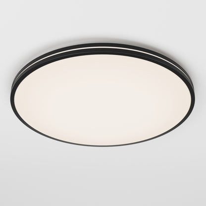 The Artika Athos 21 in. LED flush mount light features a modern round design with a black rim, smooth white illuminated surface, and comes with a remote for easy control, shown mounted on a plain white ceiling.