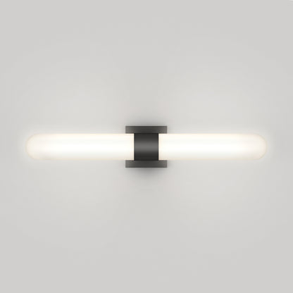 The Artika Wilton LED modern bathroom vanity light 5 CCT features a horizontal frosted glass shade and central black base, wall-mounted to emit a soft white glow against a light gray wall.
