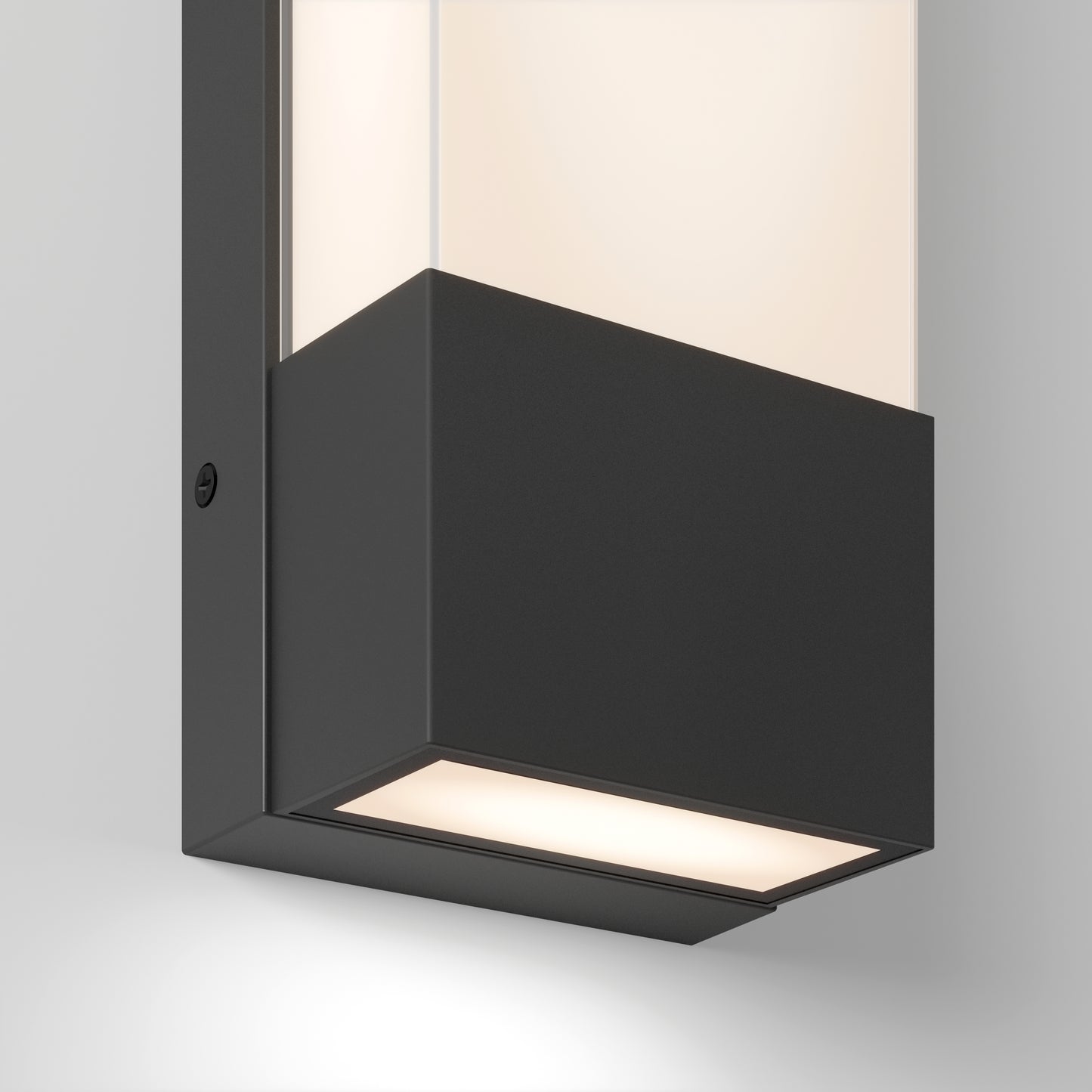 The Artika Dixon indoor-outdoor LED wall light features a matte black rectangular base and frosted glass top, casting soft white light upward and downward against a light gray wall.