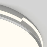 A close-up of a circular, modern ceiling light fixture with a segmented, glowing LED ring and a metallic or silver frame against a light gray background.