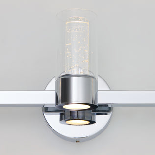 The Artika Novello modern LED bathroom vanity light features a chrome finish and a clear, bubbled glass shade.