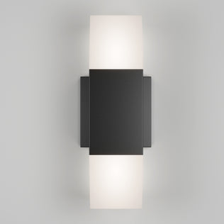 The Artika Lennox indoor-outdoor LED wall light 3 CCT features a sleek black rectangular design with soft white light glowing from the top and bottom edges, displayed against a light gray background.