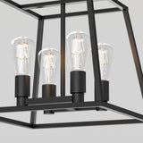 Close-up of a modern black metal chandelier with four exposed vintage-style filament light bulbs, set against a plain light gray background.