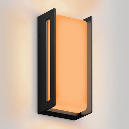 The Artika Ryker smart RGB indoor-outdoor wall light features a rectangular black metal frame and warm orange panel, mounted on a white wall.