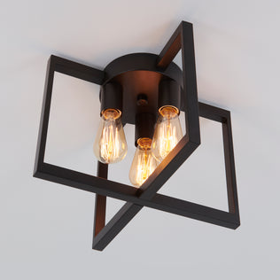 The Artika Yale 3-light 15 in. Flush Mount features black geometric frames and exposed bulbs for an industrial ceiling light style.