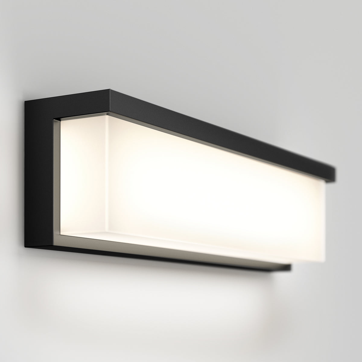 A modern, rectangular wall sconce with a black frame and a frosted white light panel, mounted on a plain light gray wall.