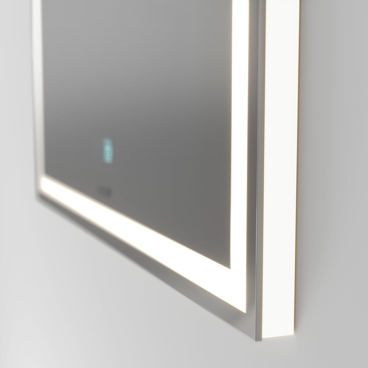 Close-up of a modern rectangular mirror with built-in LED lights glowing along the edges, mounted on a light-colored wall. A small touch button is visible on the mirror’s surface.