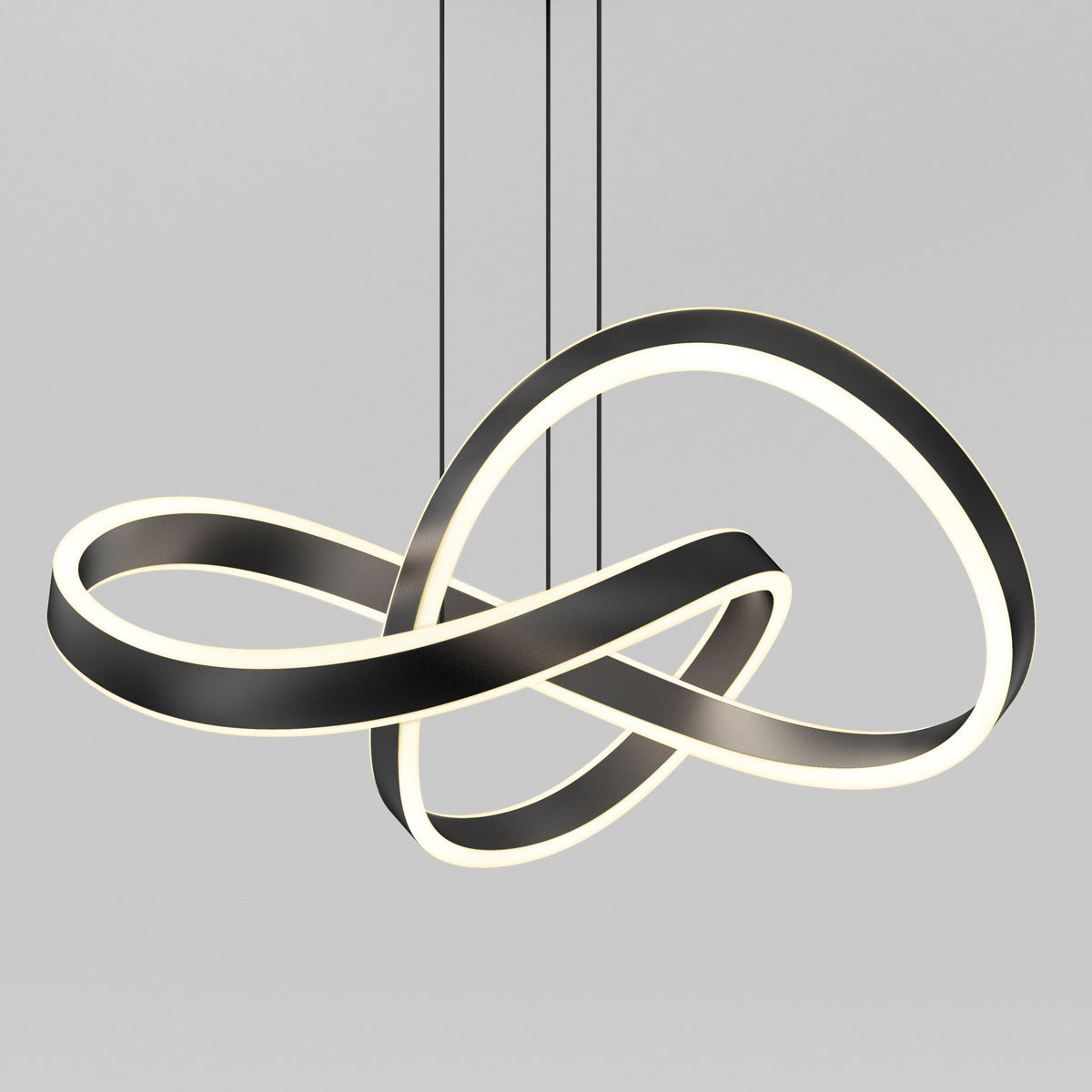 The Artika Bolero LED pendant light 5 CCT features intertwined black and white LED loops in an abstract infinity shape, suspended by slim black cables against a plain gray background.