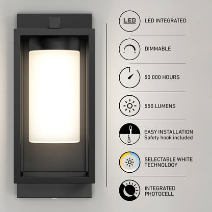 The Artika Aurel Outdoor LED Light, 3CCT, is a modern rectangular sconce with a frosted cylindrical shade. Features include integrated LED, dimmable light, 50,000-hour lifespan, 550 lumens, selectable white (3CCT), easy installation, and photocell.